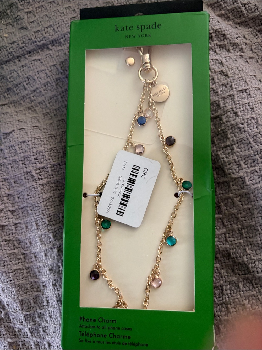 kate spade gold-tone phone charm with green, teal, blue, purple and blush stones